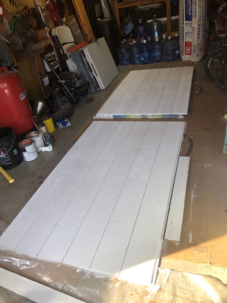 Two freshly primed pieces of siding